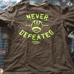 Never defeated football shirt size youth medium